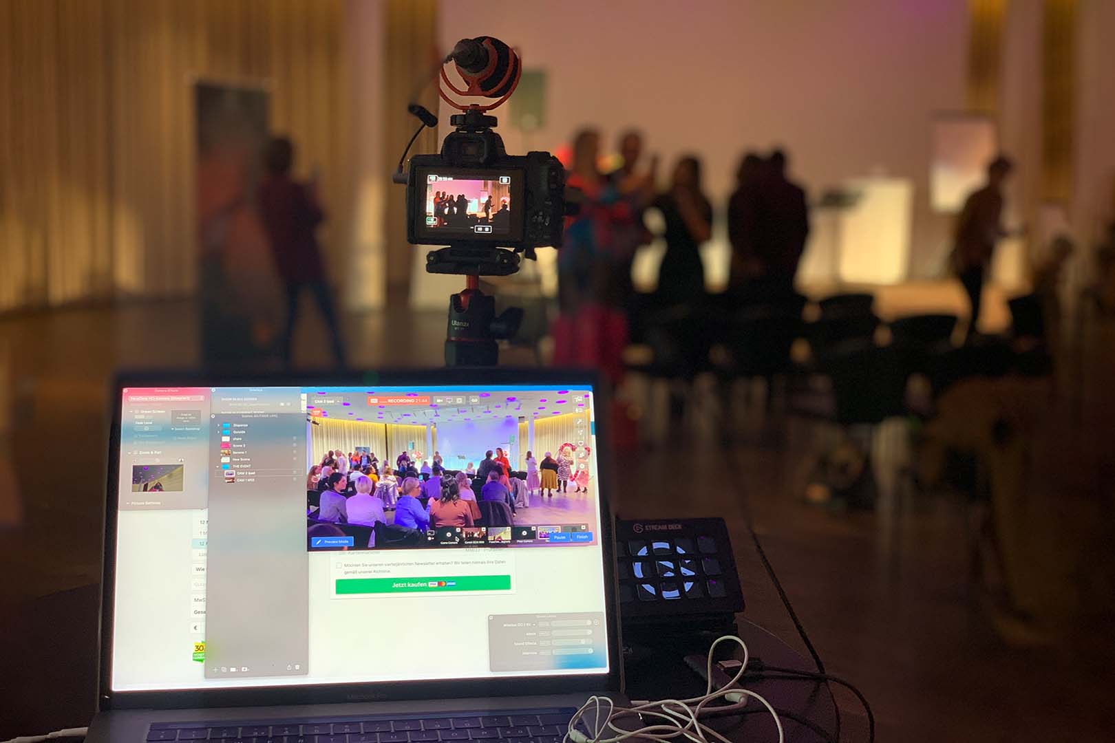 Professional camera on a tripod and a laptop running multi-scene streaming software at a live celebration online from around the world