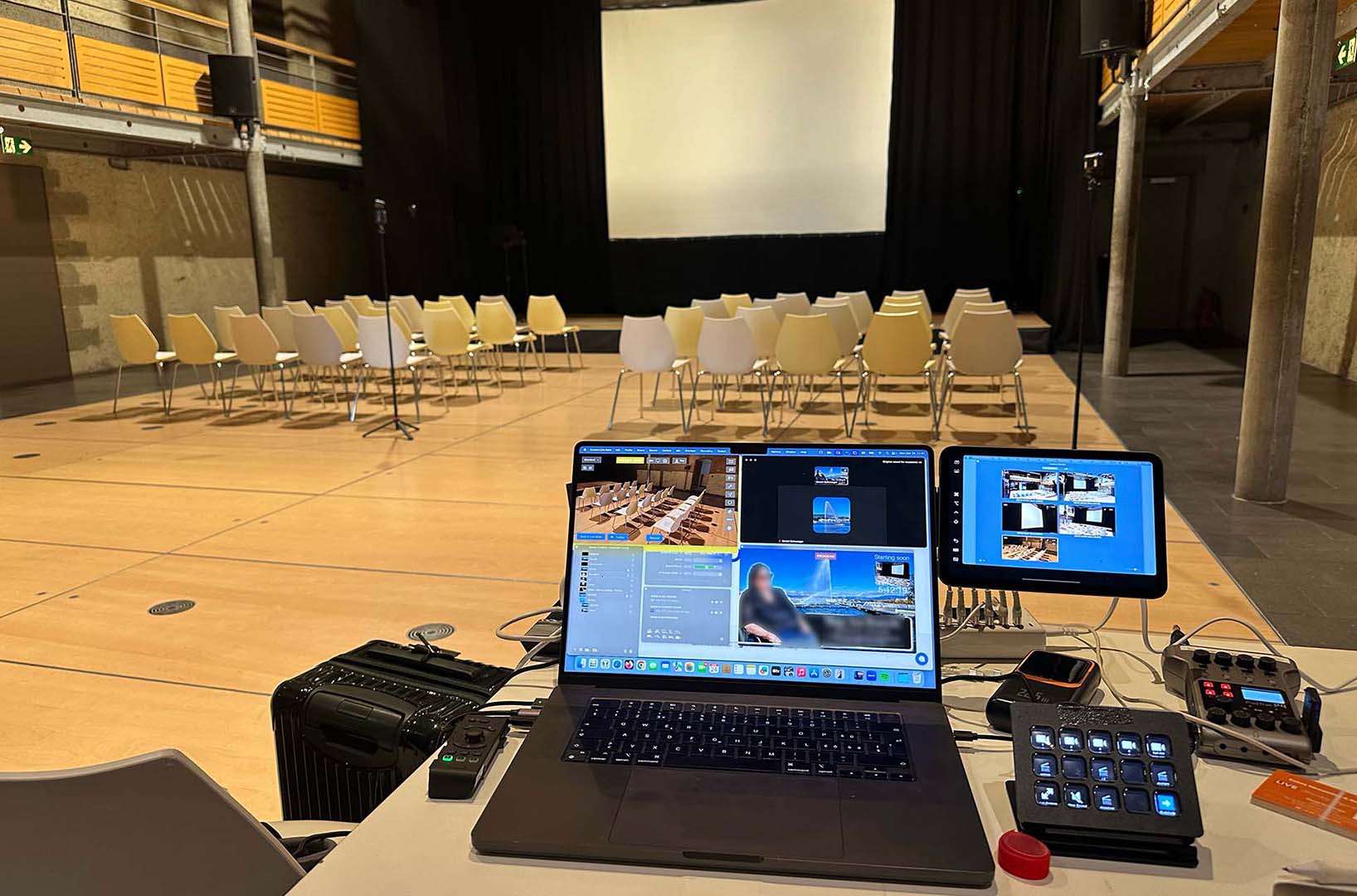 Discreet wedding live streaming station with laptop and tablets set up in an elegant venue